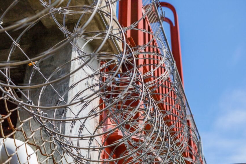 Razor wire atop a perimeter fence at a secured facility