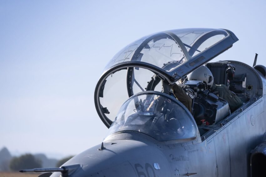 Close-up of a military fighter jet cockpit with pilots.