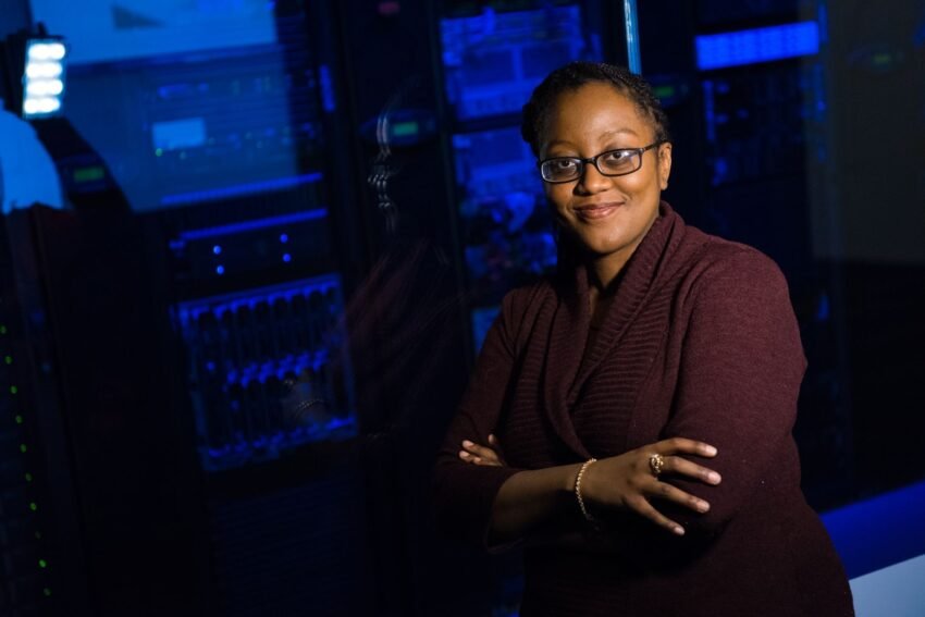 IT professional standing beside data center equipment